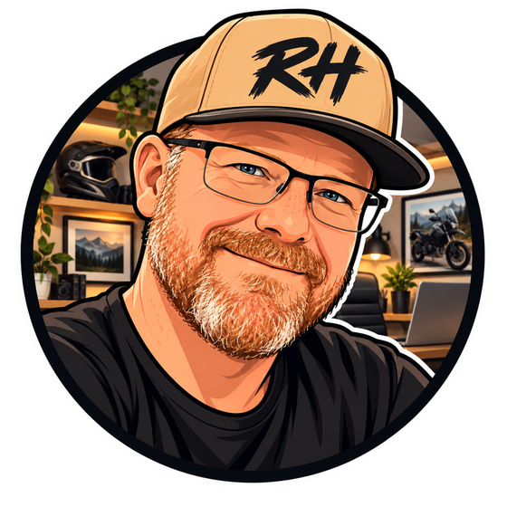 Cartoon portrait of Ron in a tan RH cap, glasses and red beard